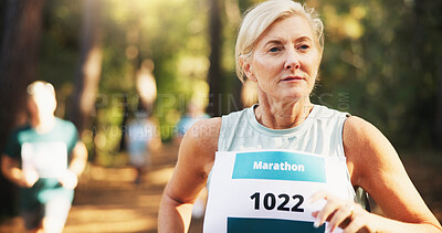Buy stock photo Competition, marathon and running with woman in forest for challenge, performance or race. Action, cardio and fitness with mature runner at rally event in nature or woods for course, heat or trial