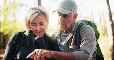 Buy stock photo Directions, phone and pointing with old couple in forest together to search for destination. App, lost and mobile map with senior people outdoor in nature or woods for exercise, fitness or health