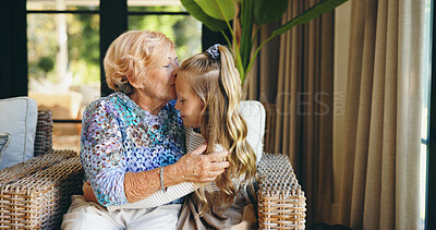 Buy stock photo Bonding, family or kiss with grandmother and grandchild on sofa in living room of retirement home for visit. Hug, love or relax with happy girl and old woman in apartment for weekend conversation