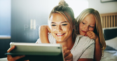 Buy stock photo Happy mother, child and relax with tablet on bed for online entertainment, show or cartoon at home. Mom, daughter or kid lying with smile on technology for subscription, app or streaming in bedroom
