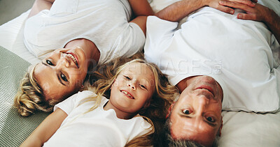 Buy stock photo Portrait, parents and child relax on bed with love, security and bonding together in bedroom. Above, smile and people rest with kid for support, care and family relationship of weekend break at house