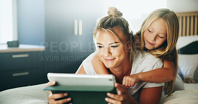 Buy stock photo Happy mom, kid and pointing with tablet on bed for online entertainment, show or cartoon at home. Mother, child or daughter lying with smile on technology for app subscription or streaming in bedroom