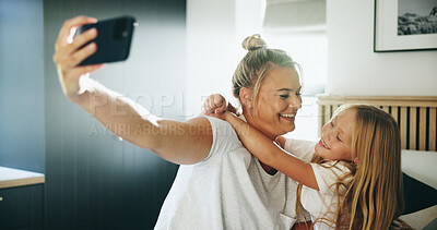 Buy stock photo Happy mom, kid and bed with hug or selfie for photography, memory or picture together at home. Mother, child or daughter with smile, love or embrace in bedroom for capture moment or bonding at house