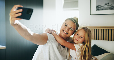Buy stock photo Happy mom, child and bed with hug for selfie, photography or picture together at home. Mother, kid or daughter with smile, love or embrace in bedroom for capture moment, bonding or memory at house