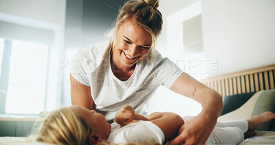 Buy stock photo Home, mom and girl with tickle for playing, laughing and bonding together with happy smile. Bedroom, mother and child with funny game for connection, childhood activity and support for trust or relax