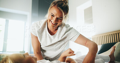 Buy stock photo Home, mom and child with tickle for playing, laughing and bonding together with happy smile. Bedroom, mother and girl with funny game for connection, childhood activity and support for trust or relax