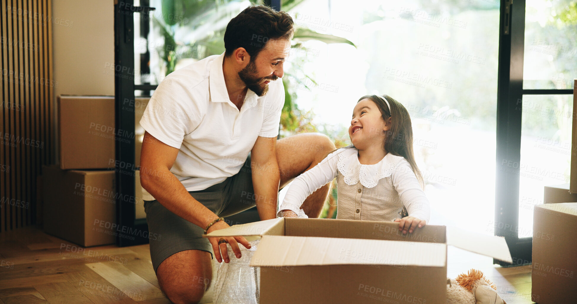 Buy stock photo Box, moving in or unpacking with dad and daughter in new home for property or real estate investment. Growth, happy or relocation with single parent man and girl child in apartment for mortgage