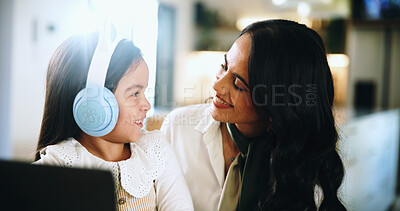 Buy stock photo Laptop, headphones and mom with daughter at home for elearning, homework and streaming. Helping, support and online class with woman and child in family house for student app and remote school
