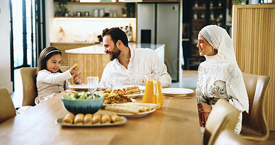 Buy stock photo Smile, muslim family and food at house for Eid lunch, healthy meal and feast of celebration. Happy, parents and child play with snack for nutrition, cuisine and bonding together for Islamic tradition