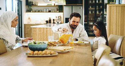 Buy stock photo Muslim, family and child with juice at house for Eid lunch, healthy food and feast for celebration. Happy, father and girl with meal for nutrition, religious event and cuisine for bonding together