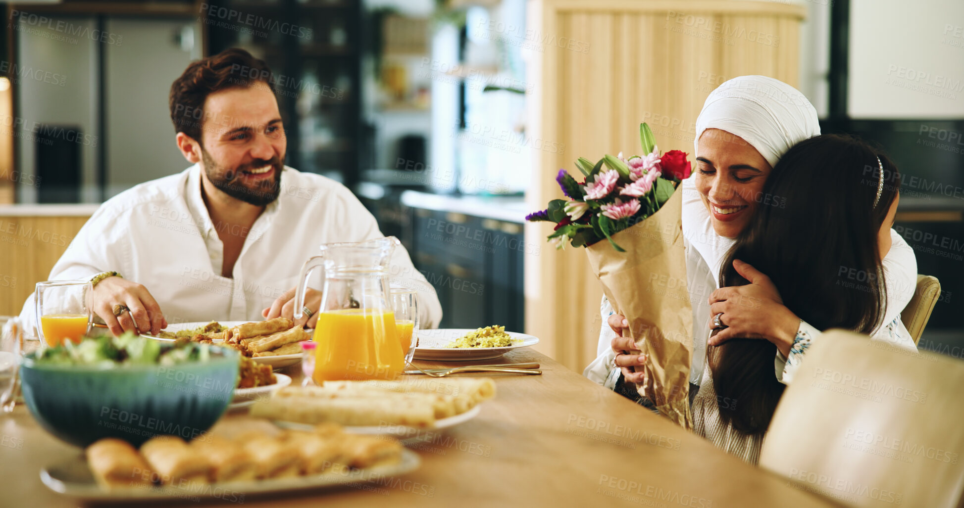 Buy stock photo Muslim, parents and hug child for flowers at lunch with mothers day surprise, birthday present and gratitude. Happy family, home and woman with bouquet gift at dinner for celebration or special event