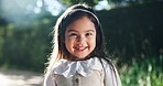 Happy, cute and portrait of child outdoor in backyard with excitement for new home in garden. Smile, sweet and face of girl from London with relax and positive attitude for moving with family house.