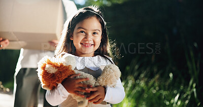 Buy stock photo Kid, moving and happy with teddy bear by new home for property relocation, mortgage investment or space. Girl person, excited and stuffed animal outdoor by dream house for arrival or childhood memory