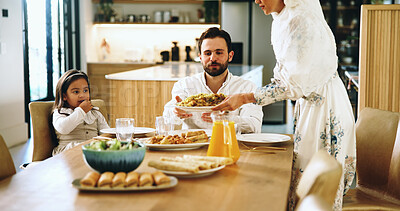 Buy stock photo Islamic family, serving and food at house for Eid lunch, healthy meal and feast for celebration. Parents, man and child eating of nutrition, religious event dish or cuisine of muslim culture