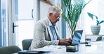 Laptop, typing and mature businessman in office with company investment planning for proposal. Computer, research and male finance banker with email communication with client for financial report.