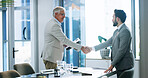 Happy, men and handshake with employee, office and documents with info for pitch and collaboration. People, colleagues and shaking hands for agreement in business, teamwork or paperwork with proposal