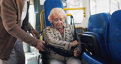 Buy stock photo Elderly woman, wheelchair and seatbelt in bus with partner, safety and helping hand for travel in town. Senior couple, support and person with disability, mobility aid or retirement with trip in city