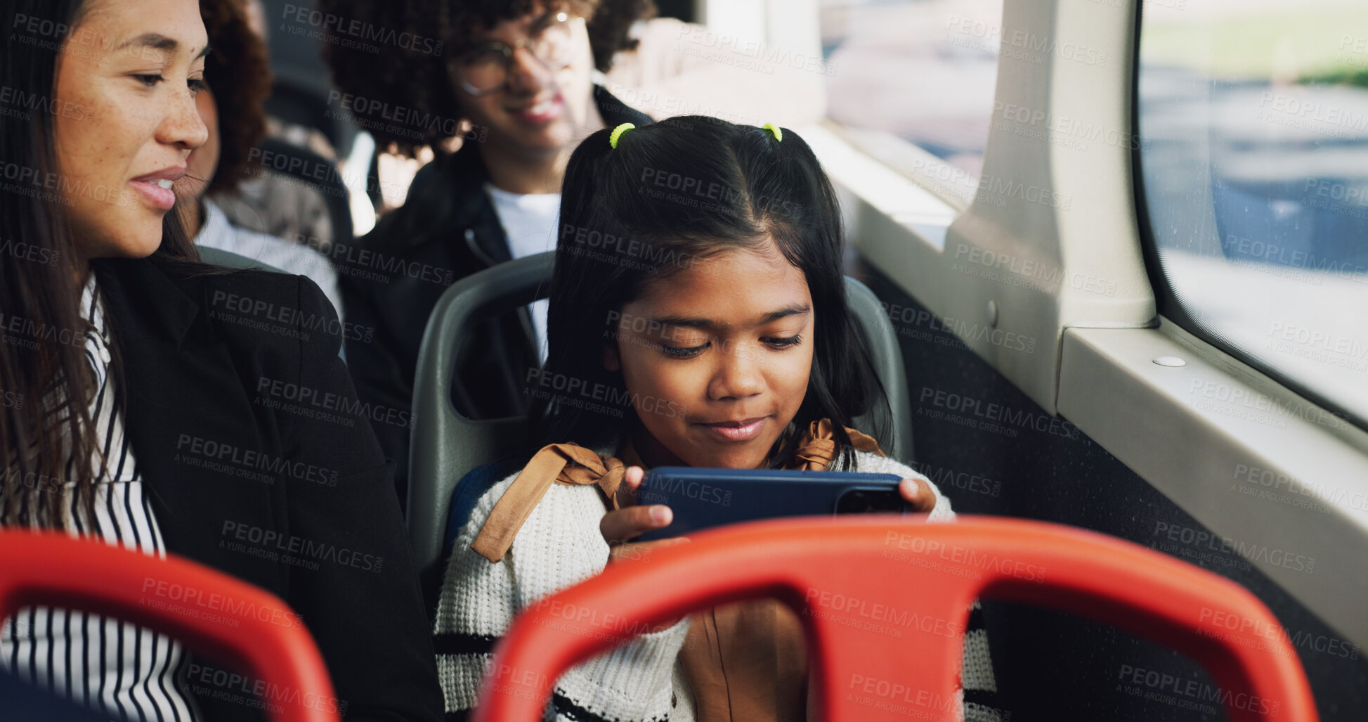 Buy stock photo Girl, child and play with phone on bus for entertainment, online streaming or watching in vehicle with mom. Kid, traveler and smile with smartphone in public transport for movie subscription app