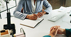 Business people, hands and writing with book in meeting for proposal, agenda or tasks at office desk. Team, employees or colleagues taking notes with diary or notebook for reminder, planning or ideas