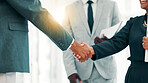 Business people, handshake or meeting with team for partnership, b2b or deal together at office. Closeup, employees or colleagues shaking hands with lens flare for career agreement or job opportunity