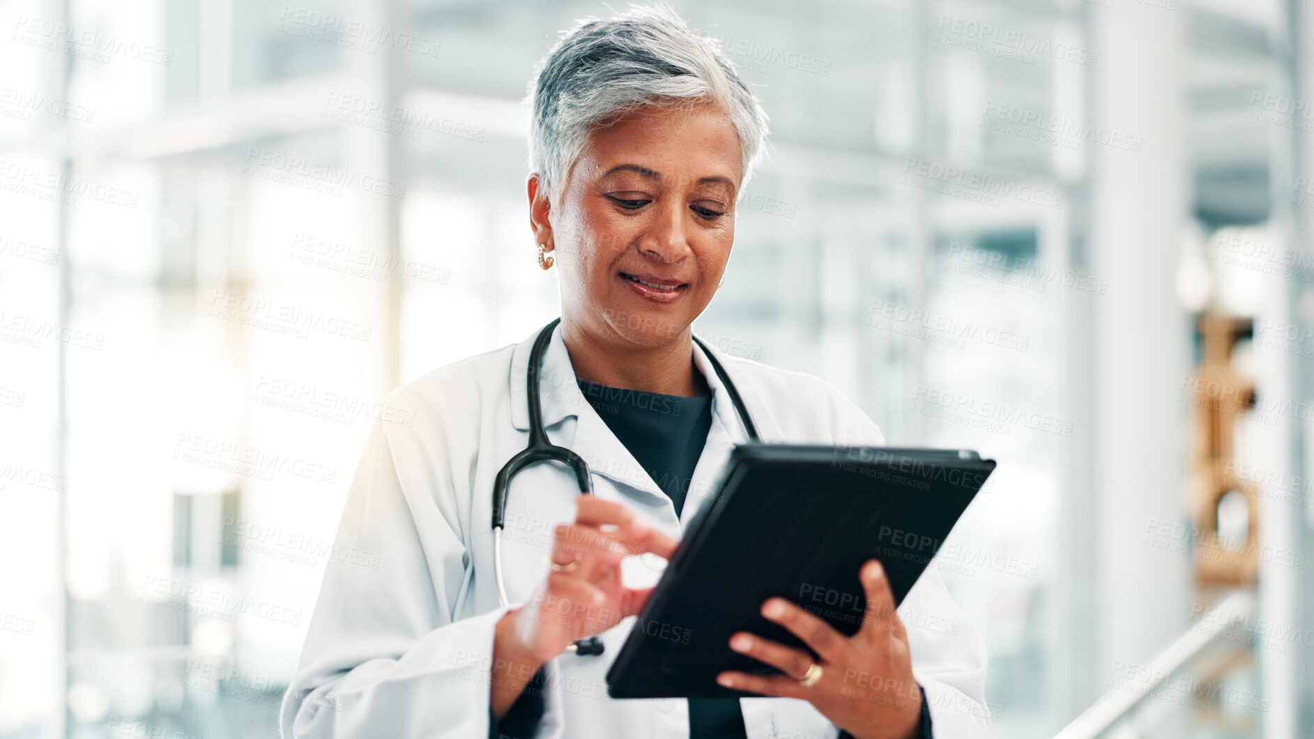 Buy stock photo Mature woman, doctor and research with tablet for medical discovery, news or healthcare service at hospital. Female person, health worker or executive browsing with technology for telehealth or app