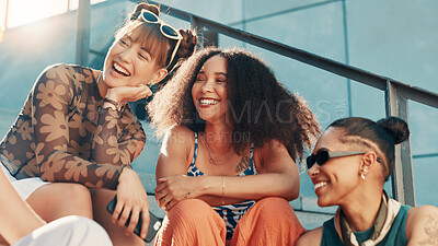 Buy stock photo Laughing, fashion and friends in city on steps in cool clothes, casual outfit or modern style. Relax, talking or trendy women with smile in urban town for holiday, streetwear or vacation together