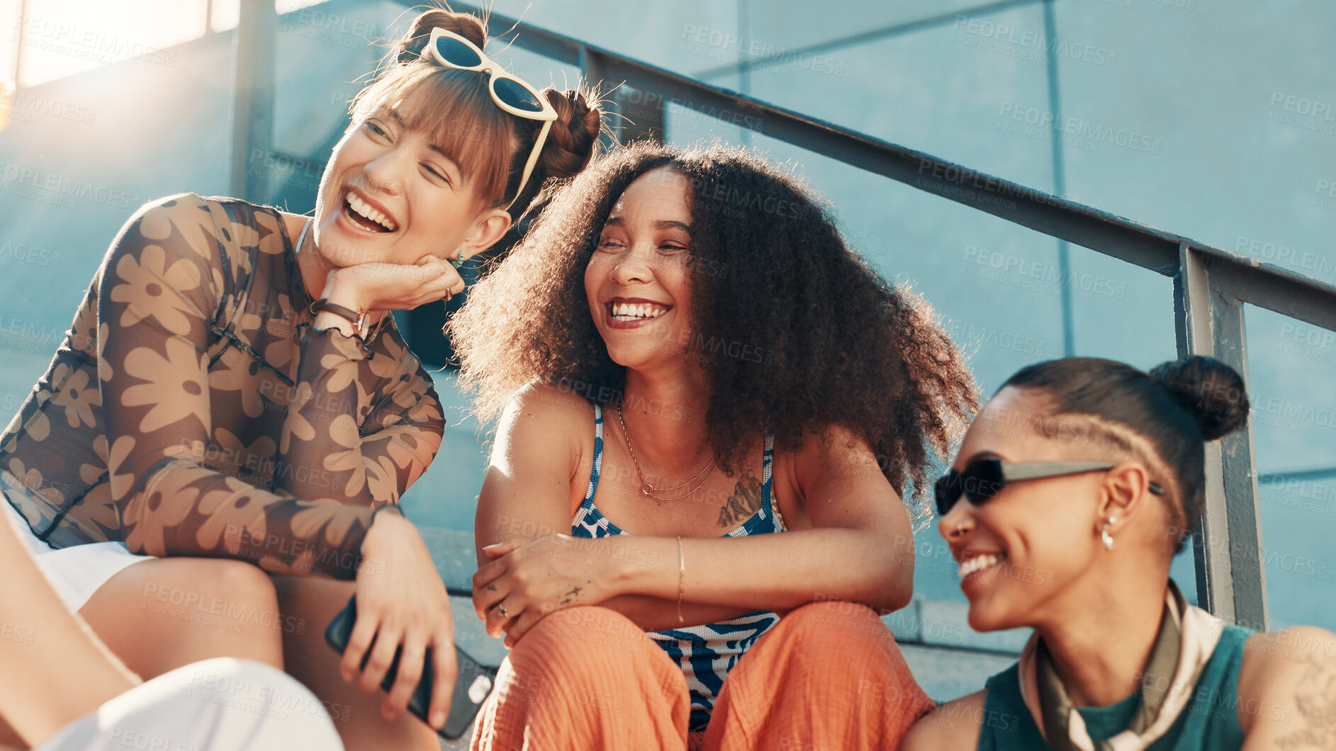 Buy stock photo Laughing, fashion and friends in city on steps in cool clothes, casual outfit or modern style. Relax, talking or trendy women with smile in urban town for holiday, streetwear or vacation together