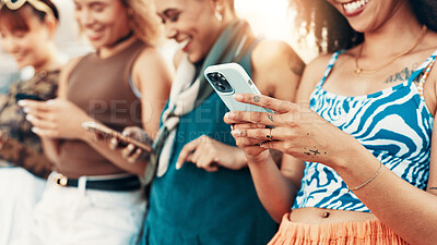 Buy stock photo City, hands and group of friends with smartphone, gen z fashion or online application for gossip. Urban, cool style and women in row with technology for network, social media or chat on internet post