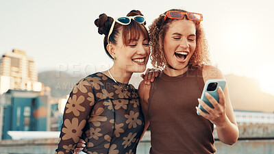 Buy stock photo City, women and friends with smartphone for laughing, gen z fashion and application for gossip. Urban, cool style and people with technology for connection, social media and internet post with smile