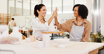 Buy stock photo Pottery class, high five and women in ceramic workshop with help, achievement and clay product. Advice, small business or mentor in studio with support, feedback and sculpture design mold or smile