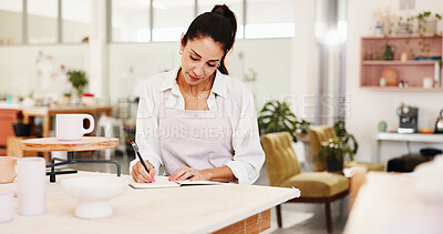 Buy stock photo Creative, clay shop and woman with notebook, artisan and tracking of stock, serious and small business. Pottery, entrepreneur and person with info for financial records, writing and sales in startup