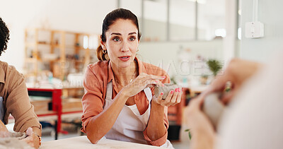 Buy stock photo Pottery class, teaching and woman in ceramic workshop for help, conversation and clay product. Instructor, small business and mentor in studio for support, feedback and creative sculpture design mold