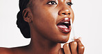 Black woman, lip gloss and beauty in studio for makeup, application and results by white background. African person, girl and test product for mouth with liquid, glow and cosmetics with process