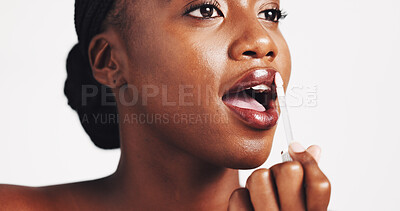 Buy stock photo Black woman, lip gloss and beauty in studio for makeup, application and results by white background. African person, girl and test product for mouth with liquid, glow and cosmetics with process