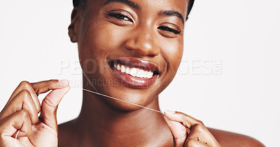 Buy stock photo Portrait, black woman and smile with floss in studio of teeth whitening, dental hygiene and oral care. Happy, person and string with veneers, fresh breathe and clean results on white background