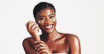 Portrait, skincare and woman with cream, studio and moisturizing of face with lotion, hydration and smile. White background, happy and black person with cosmetics for treatment, glow and smooth skin