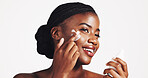Skincare, cream and woman with product, studio and moisturizing of face with lotion, hydration and smile. White background, happy and black person with cosmetics for treatment, glow and smooth skin