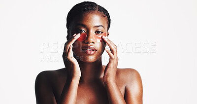 Buy stock photo Black woman, portrait and eye patches with collagen or hydration on a white studio background. Face, female person or model with facial gel mask or cosmetics for dermatology or anti aging treatment