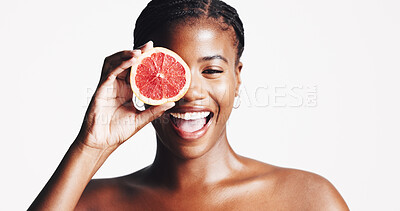Buy stock photo Happy, black woman and portrait with grapefruit for skincare, detox or vitamin C on a white studio background. Female person, model or smile with natural organic fruit for facial treatment on space
