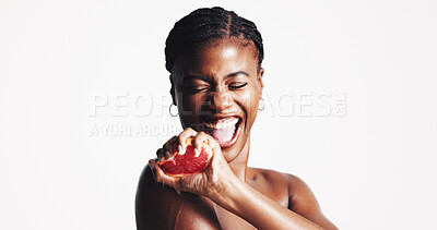 Buy stock photo Skincare, happy and black woman with fruit in studio for wellness, organic cosmetics or vitamin c. Smile, spa and person squeeze grapefruit for natural beauty, health or benefits on white background