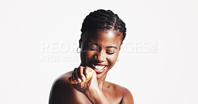 Buy stock photo Skincare, happy and black woman with fruit in studio for wellness, organic cosmetics or vitamin c, Dermatology, spa and person squeeze lemon for natural beauty, health or benefits on white background