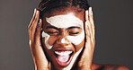 Beauty, skincare and clay mask with black woman in studio for facial, spa treatment and dermatology. Cosmetics, self care and pore cleaning benefits with person on dark background for glow and shine