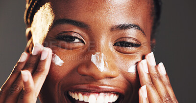 Buy stock photo Happy, black woman and portrait with face cream in studio for skincare on a gray background. Closeup, female person or model with smile in satisfaction for lotion, moisturizer or facial treatment
