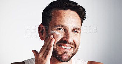 Buy stock photo Apply, portrait and happy man with face cream for anti aging, skincare space or collagen. Smile, wrinkle treatment or male person on white background in studio for cosmetics, beauty or facial lotion