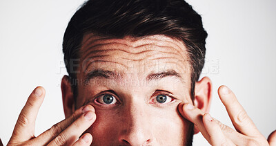 Buy stock photo Man, studio and stress with eye irritation on white background with infection, glaucoma and concern. Contact lenses, portrait and person frown with reaction to allergy, vision loss or retina wellness