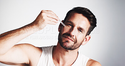 Buy stock photo Portrait, skincare and serum with man in studio for anti aging, wrinkles treatment and collagen production. Dermatology, hydration and oil with mature person on white background for beauty cosmetics