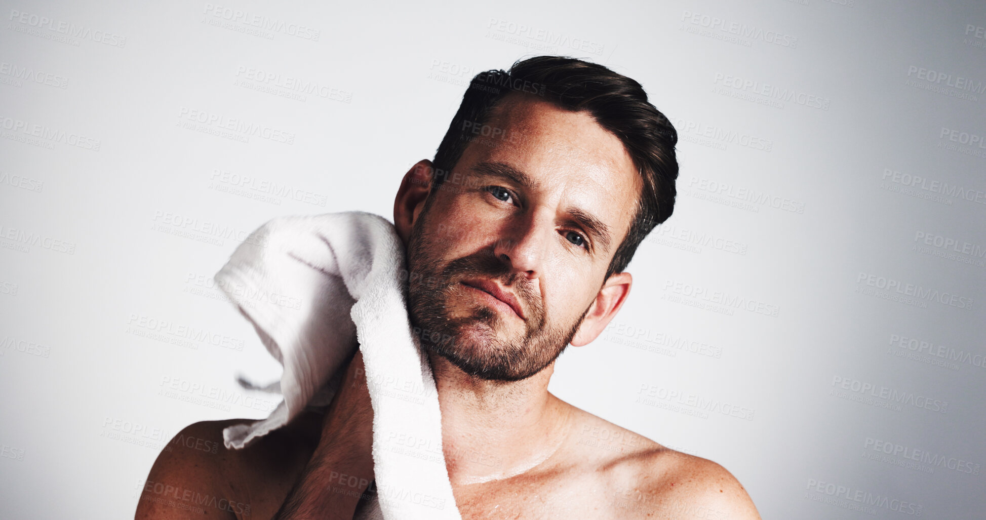 Buy stock photo Portrait, man and towel for skincare in studio of cleaning, grooming routine and facial hair removal. Male person, drying face and fresh shave for hygiene care, beard maintenance and white background