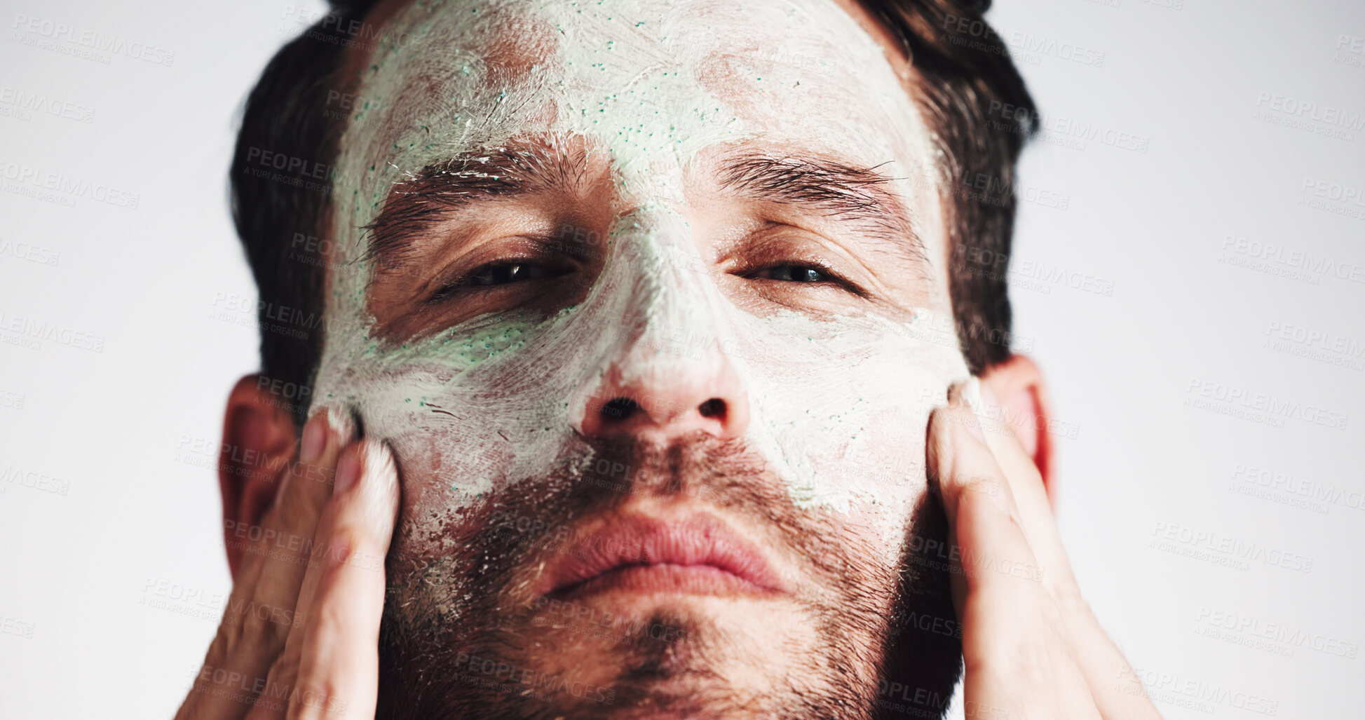 Buy stock photo Facial, skincare and clay mask with portrait of man in studio for beauty, spa treatment and dermatology. Cosmetics, self care and pore cleaning benefits with person on white background for glow