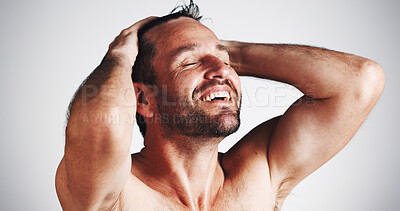 Buy stock photo Smile, hair care and beauty with man in studio for shower, scalp health and dandruff treatment. Growth, texture and grooming with person on white background for cosmetics, shine and cleaning