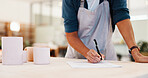 Workshop, hands and inspection with paperwork for pottery, small business and notes for stock management. Closeup, person and potter with document for writing, order information and cups as product